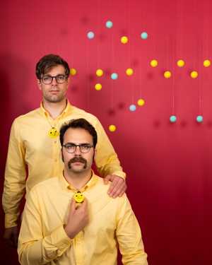 The Robo Bingo poster photo. Lloyd and Peter standing in front of floating bingo balls.